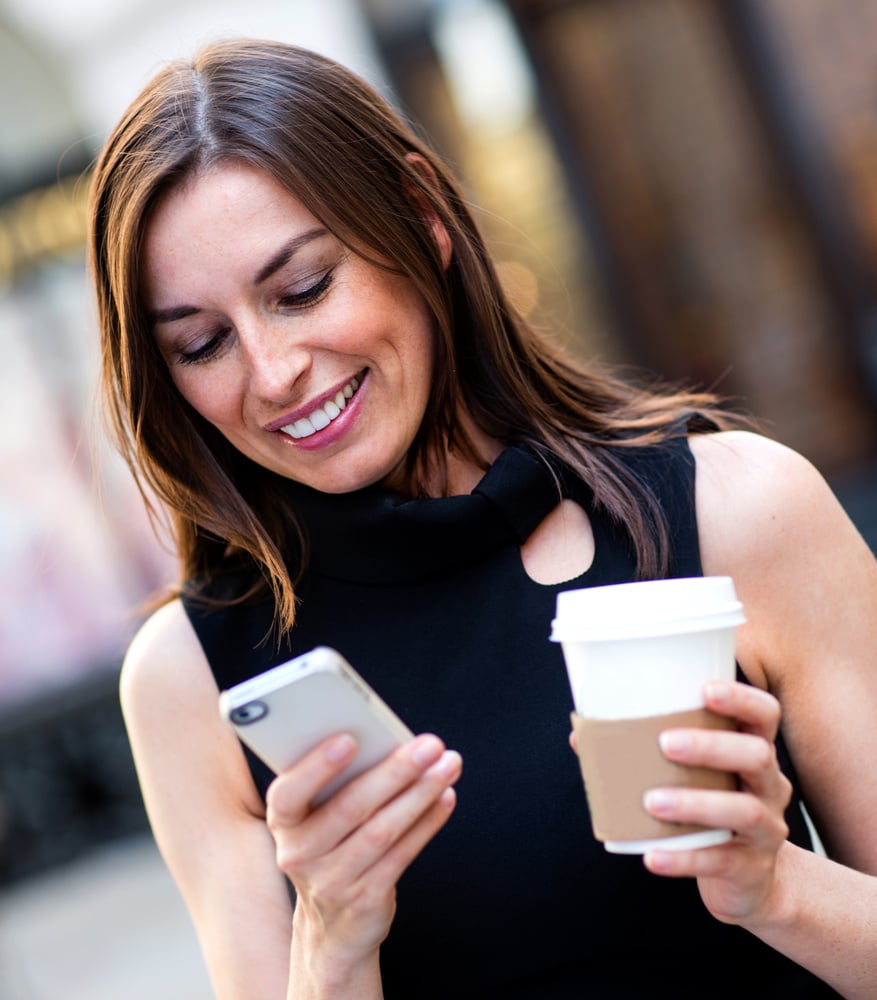 Busy business woman texting on her cell phone